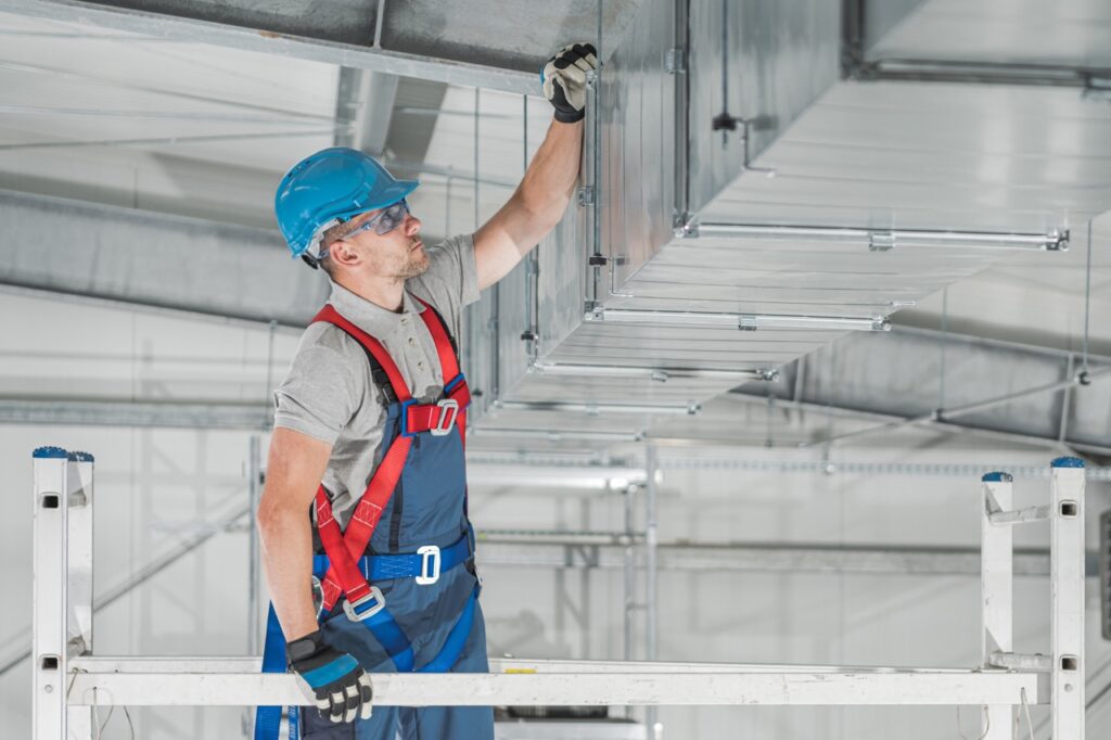 commercial,hvac,systems,installation,inside,the,warehouse,performed,by,caucasian